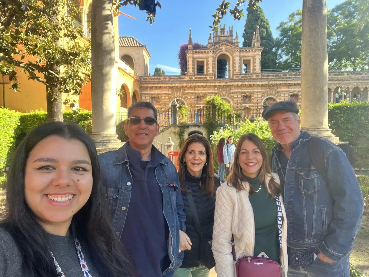 Private guide and guests take a selfie in the Royal Alcázar gardens on a Seville tour